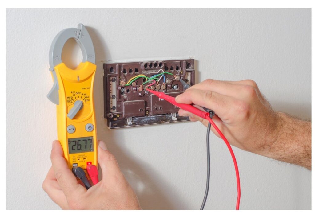 heating technician testing a home thermostat